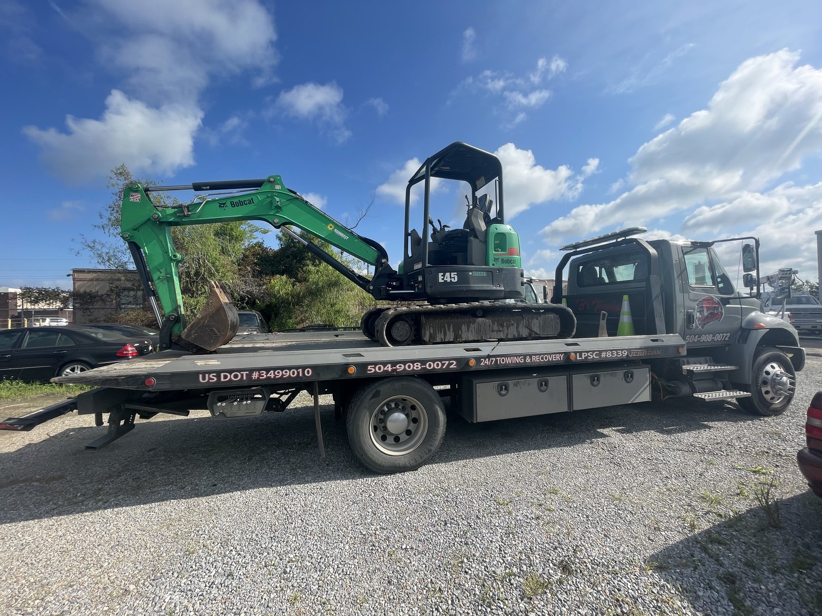Compact excavator secured on a B’s Towing flatbed
